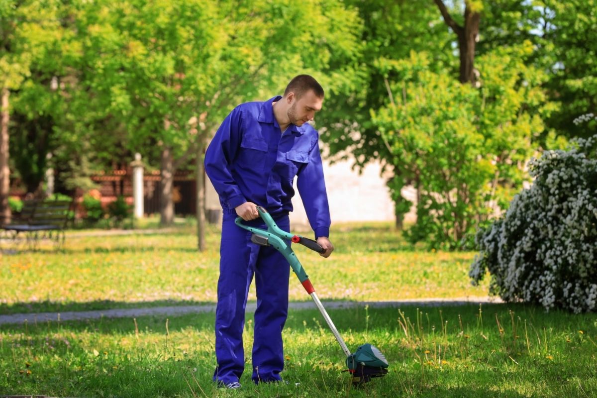 Young Worker Mowing Lawn